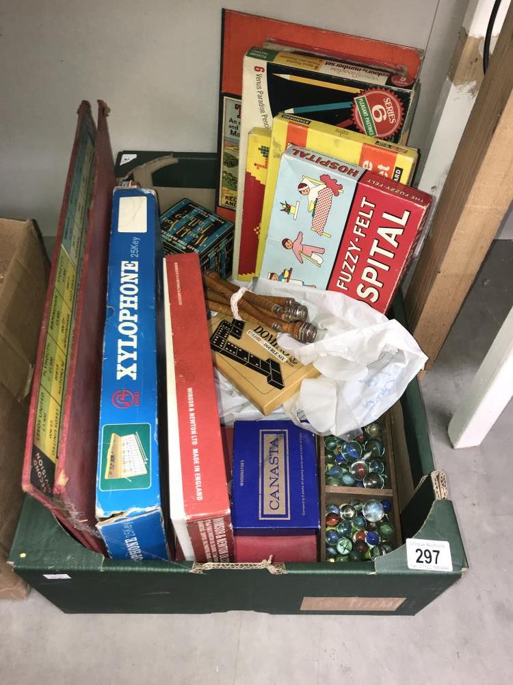 A box of old games including 1960's Fuzzy-felt hospital, marbles, xylophone etc.