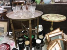 An Indian brass top table and 1 other