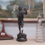 A spelter figure of a boy with birds signed L Raphael.