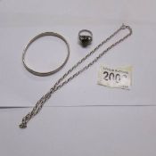 A silver neck chain (5 grams), a silver bangle (4 grams) and a white metal ring.