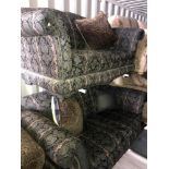 A pair of green and black paisley and striped upholstered 2 seat sofas