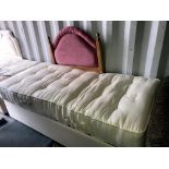 A single mattress and electric bed base with pine head board