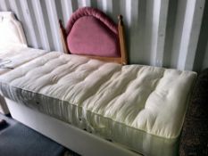 A single mattress and electric bed base with pine head board