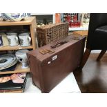A vintage suitcase and a wicker basket