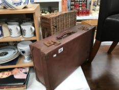A vintage suitcase and a wicker basket