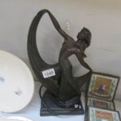 An art deco style lady table lamp, missing glass.