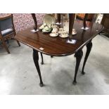 An Edwardian mahogany drop leaf table with Queen Anne legs
