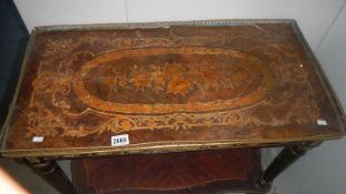 An early 19th century French marquetry inlaid table with brass gallery.