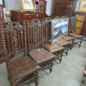 A set of 6 carved oak dining chairs.