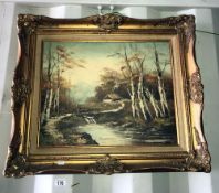 A decorative gilt framed oil on canvas of a woodland stream and cottage