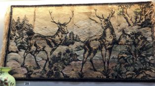 A tapestry wall hanging of deer