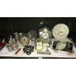 A shelf of clocks, pewter tankards, aeroplane cruet etc.