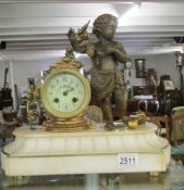A French bronze and marble clock surmounted cherub (with key).