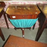 A Victorian mahogany sewing table with contents.