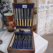 An oak cased cutlery set.
