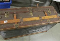 A vintage steamer trunk with interior tray.