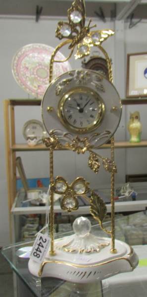A decorative ceramic and gilt clock.