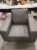 A grey fabric arm chair