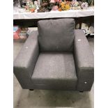 A grey fabric arm chair