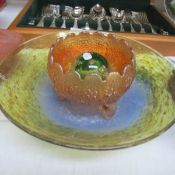 A glass art deco bowl, a carnival glass bowl and a signed glass paperweight.