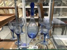 A quantity of blue coloured wine glasses and a decanter