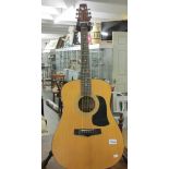 An Aria Acoustic model AW100 guitar (stand not included).