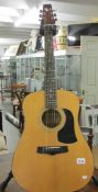 An Aria Acoustic model AW100 guitar (stand not included).