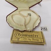 A pearl necklace by Rosita with guarantee dated 3/10/90, in case.