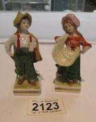 A pair of Sitzendorf boy and girl figures.
