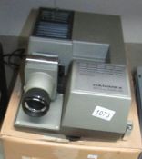 A boxed Hanimex Syllabus 2000 slide projector with instruction booklet.
