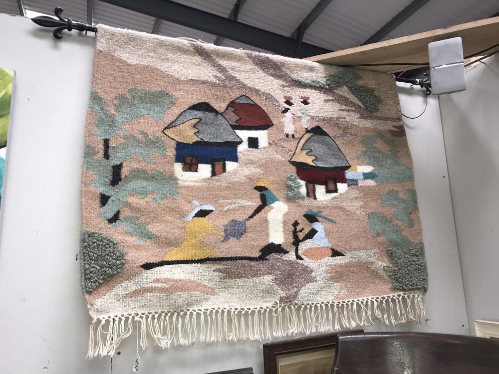 A woolwork wall hanging of a stylized African village