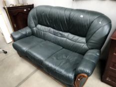 A green leather 3 seater settee