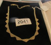 A cased 18ct gold necklace, approximately 28 grams.