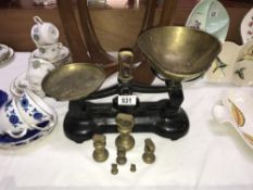 A cast iron Libra Scale company kitchen scales with brass pans and weights