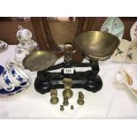 A cast iron Libra Scale company kitchen scales with brass pans and weights