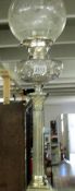 A silver plated oil lamp with Corinthian column, glass font and etched shade.