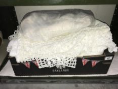 A box of linen crocheted throws