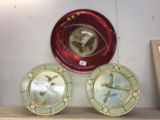 A retro metal wall plaque and a pair of lacquered wall plaques depicting birds