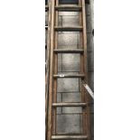 A set of wooden double extending ladders