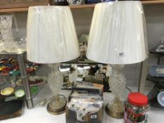 A pair of ornate table lamps with glass centres