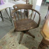 An oak swivel office chair with makers label for J & H Bell, Nottingham.