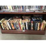 A shelf of paperbac books including Sci-Fi