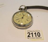 A silver pocket watch incorporating stop watch.