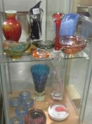 2 shelves of coloured glass vases and bowls.
