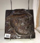 A carved wood plaque depicting fisherman