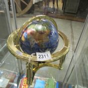 A gem set table globe on brass stand.