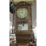 A Victorian inlaid wall clock with key and pendulum.