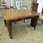 A Victorian mahogany wind out table with 2 extra leaves and complete with handle.