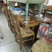 A good oak draw leaf dining table with 6 ladder back chairs.