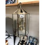 An antiqued brass finished hall lantern with 8 bevelled glass panels